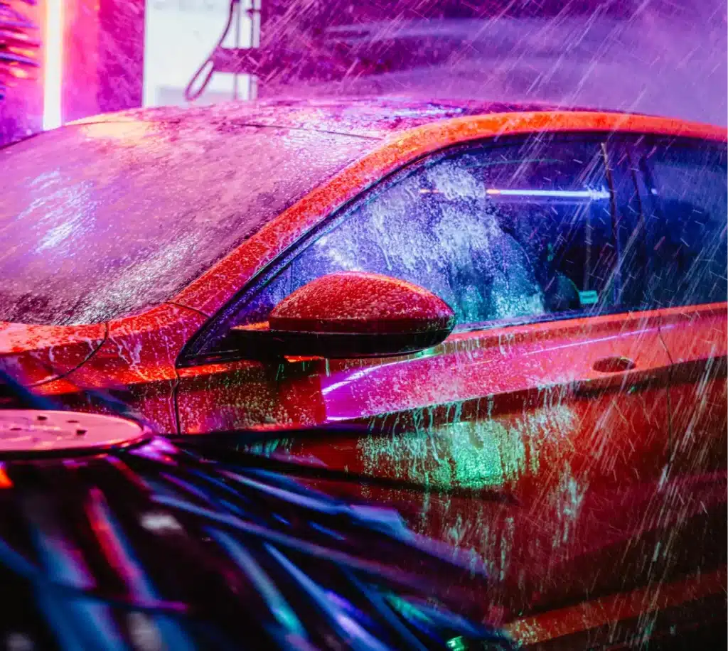 Water Recycling: How Car Washes Are Redefining Water Reuse 1 Red Car Getting Washed at Mint Smart Wash | Water Recycling: How Car Washes Are Redefining Water Reuse